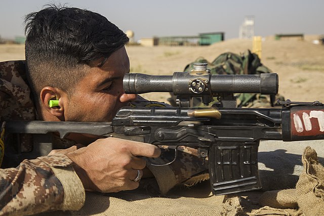 An Iraqi Ground Forces soldier aiming through his SVD rifle's POSP sight