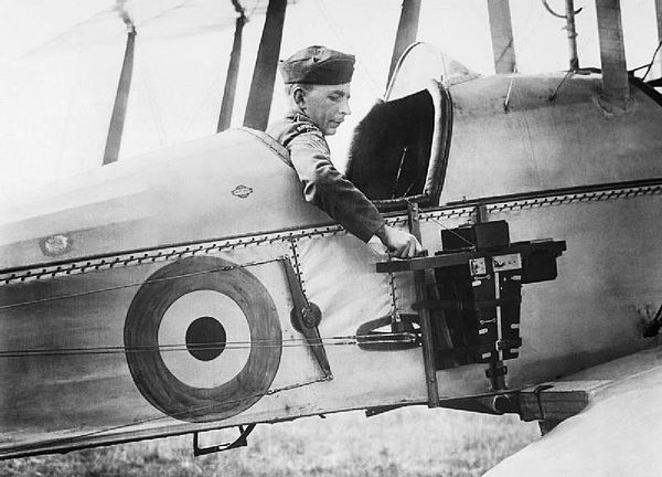 An observer of the Royal Flying Corps in a Royal Aircraft Factory B.E.2c reconnaissance aircraft demonstrates a C type aerial reconnaissance camera fi