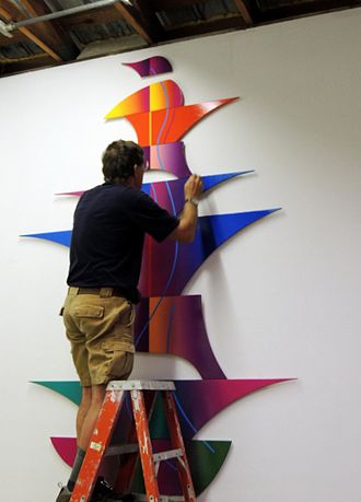 Ray L. Burggraf, assembling a recently completed color construction (2012). Photo courtesy of George Clark. Ray Burggraf installing new work.jpg