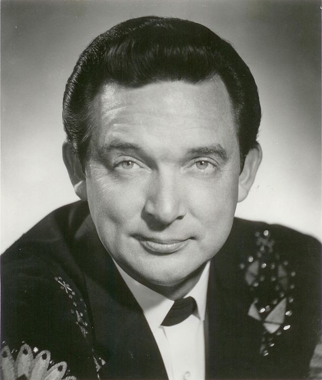 A black-haired man wearing a dark jacket