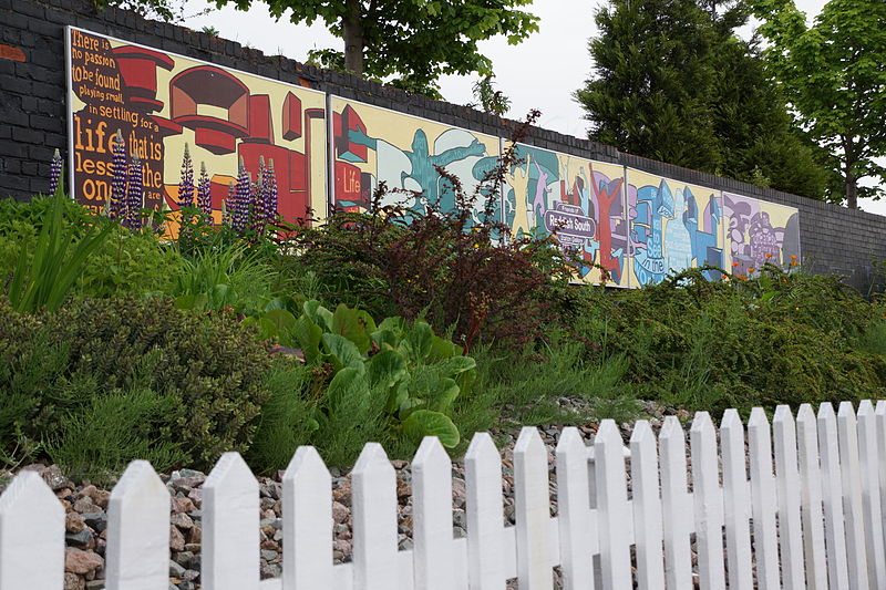 File:Reddish South artwork and flower-bed.JPG