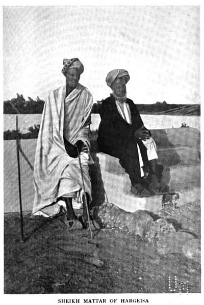 File:Sheikh Madar pictured sitting with his son to his left.jpg