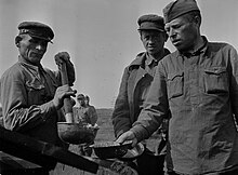 Red Army staff lieutenant and lieutenant in a soup line in Muujarvi camp near Rukajarvi road in the Muyezersky District. Soviet POWs in Muujarvi camp.jpg