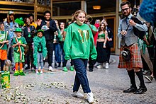 An Irish stepdancer accompanied by a bagpiper at the Cleveland Arcade, 2022 St. Patrick's Day Cleveland Arcade.jpg