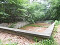 The swimming pool beneath the house, over the river