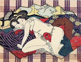 A historic shunga woodblock printing from Japan depicting two women having sex. One has tied a tengu mask around her waist, and penetrates her partner using its long nose. Two Japanese women make love.jpg