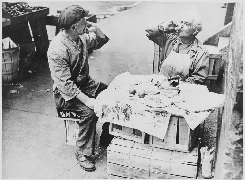 File:Two street vendors taking time out for lunch at a makeshift table of wooden crates covered with newspaper, 08-1946 - NARA - 541909.tif