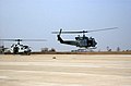 UH-1N Iroquois (Huey) utility helicopter (right) takes off from the flight line at Camp Humphreys.