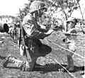 A US Marine gives candy to Japanese child at Tinian internment camp