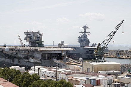 The decommissioned Enterprise alongside her replacement, USS Gerald R. Ford, at Newport News, July 2018