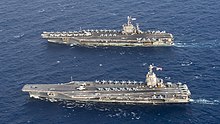 Aerial view of USS Gerald R. Ford (CVN-78), a ship of the new Gerald R. Ford-class, alongside USS Harry S. Truman (CVN-75), a ship of the previous Nimitz class USS Gerald R. Ford (CVN-78) and USS Harry S. Truman (CVN-75) underway in the Atlantic Ocean on 4 June 2020 (200604-N-BD352-0199).JPG