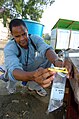 US Navy 050309-N-8629M-083 Hospital Corpsman 3rd Class Ron Berard, assigned to Navy Environmental Preventive Medicine Unit Six (NEPMU-6), takes a water sample at an internally displaced persons (IDP) camp in Banda Aceh, Indones.jpg