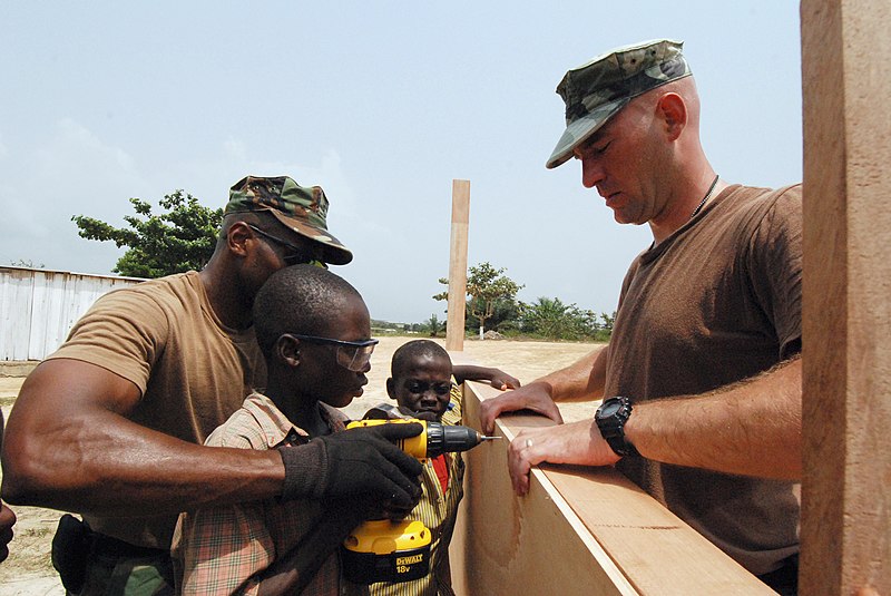 File:US Navy 080208-N-4044H-113 Utilitiesman 2nd Class Jeffery Ladd and Utilitiesman 2nd Class Paul J. Kuntz help a child drill a hole in part of a wall for a classroom at the Orphans Cry International Orphanage.jpg