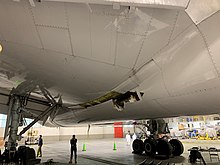 Damage to the wing and the body fairing of United Airlines flight 328 (NTSB photo) United Airlines Flight 328 damage.jpg