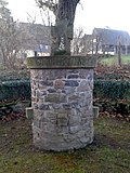 War memorial for those who fell in World War I, circular square with fence, staircase and archway as well as trees outside the square