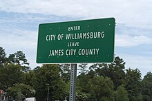 Sign marking the limits of Williamsburg, Virginia and James City County, Virginia. All cities in Virginia are independent from the counties that surround them. Williamsburg City Limits sign.jpg