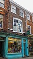 39 Stonegate. One house of terrace of three, mid C18, now shop. Grade II listed.