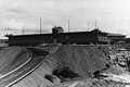 Long three-story concrete building, black and white photo