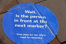 A circular blue sign stating "Wait"