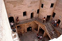 Tourists explore the château's courtyard