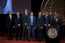 Dwayne Bray accepts the Peabody Award for Outside the Lines: NFL at a Crossroads: Investigating a Health Crisis." He is joined on stage by the crew from ESPN. Dwayne Bray and the crew of Outside the Lines at the 73rd Annual Peabody Awards.jpg