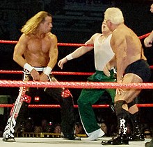 Flair and Shawn Michaels deliver knife-edged chops to Kenny Dykstra of the Spirit Squad in 2006