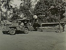 A No. 78 Squadron P-40 being towed by a jeep while at an airfield near Hollandia in July 1944
