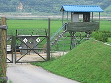 South Korean sentry post with a patrolling soldier seen from north in Korean Demilitarized Zone