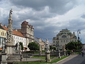 Main street in Košice, with a monument and buildings around