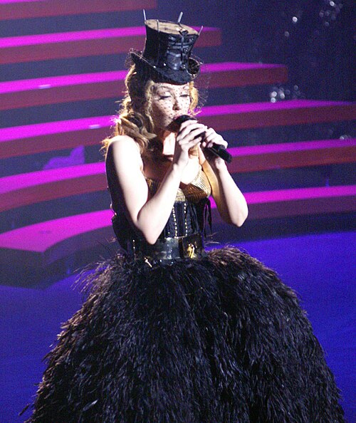 Minogue performing Aphrodite's second single, "Get Outta My Way", on her Aphrodite: Les Folies tour. The song became her fifth number one on the US Ho