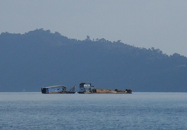 A boat carrying logs on Nam Ngum lake, 2011