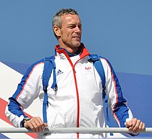 Flag bearer Mark Foster (pictured here in the celebratory parade after the Games finished) was the only swimmer allowed to take part in the 2008 opening ceremony. Mark Foster, October 2008.jpg