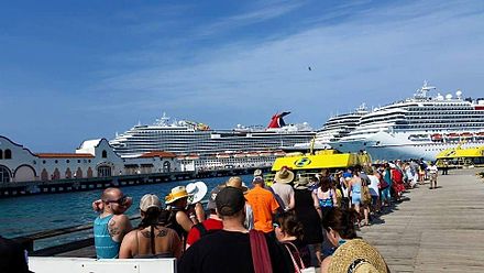 Multiple cruise ships docked in Cozumel. From left to right: Carnival Breeze, unknown, and Carnival Freedom.