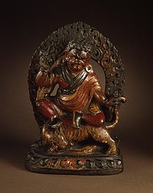 Wooden statue of Padmasambhava in his manifestation as Guru Dorje Drolo riding on a tiger Padmasambhava (Guru Rinpoche, 8th century) in his form as Dorje Drolo, Subduer of Demons LACMA M.86.281.jpg
