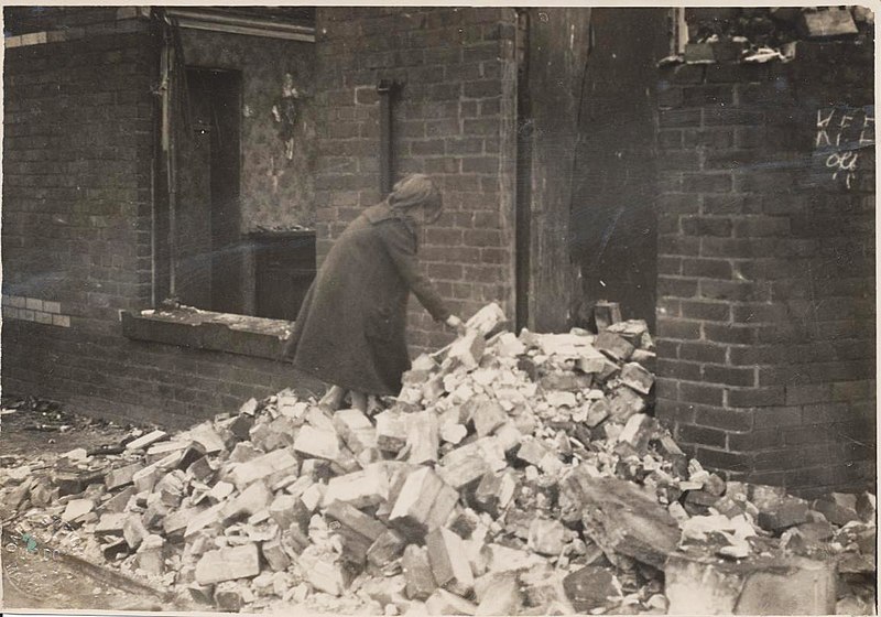 File:Photgraph of a young girl searching through rubble outside a house damaged in the Great Timber Yard Fire in Hartlepool, 1922. Although no one perished during the blze, many familes still lost (5758498840).jpg