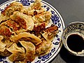 Fried dumplings, called "potstickers" or gūotiē (鍋貼) 夕食に供する焼き餃子
