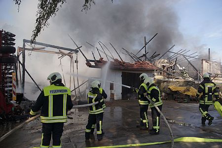 a fire of a barn in Germany, with firefighters (photo)