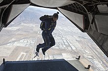 Navy parachute demonstration team member wearing a helmet cam on a jump The Leap Frogs train over San Diego. (9971308184).jpg