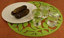 Clear vodka served with pickled cucumber - the usual way of consuming it in Slavic
countries of the so-called "vodka belt". Vodka with pickled cucumber.jpg