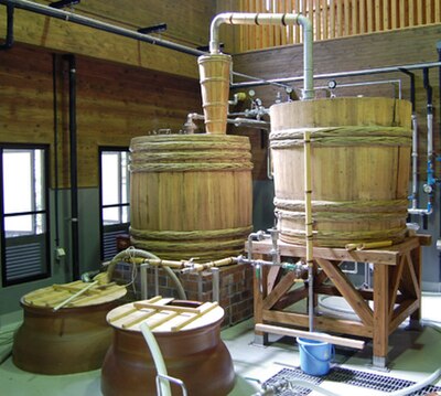 Single distillation. Wooden pot stills are most often used at smaller distilleries.