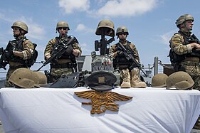 Members of the Visit, board, search, and seizure (VBSS) team gather to honor Keating during the Memorial Day ceremony aboard the Arleigh Burke-class Destroyer USS William P. Lawrence (DDG 110).