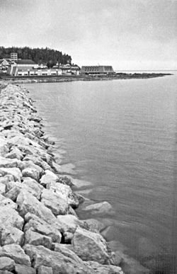 This jetty is the western boundary of Mission Point. Looking east, this 1969 view shows the Mackinac College campus, with the Peter Howard Memorial Library and Clark Center. Robinson’s Folly, the eastern boundary of Mission Point, is in the background.