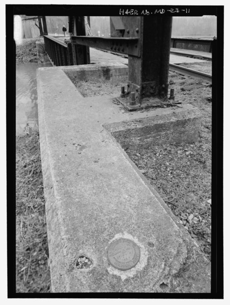 File:A U.S. Geological Survey marker embedded in the northeast corner of concrete abutment. This view also shows the basic abutment and tower footing arrangement. - Potomac Edison HAER MD,22-WILPO,1-11.tif