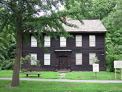 A brown colonial frame house.
