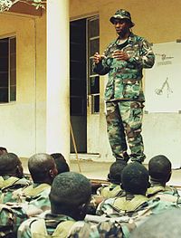 American soldier instructing Senegalese soldiers on U.N. peacekeeping policies during training for the African Crisis Response Initiative in Thies, Senegal. American soldier training Senegalese peacekeepers (Thies, Senegal).jpg