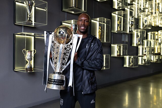 Hutchinson in Beşiktaş Stadium front of the trophy wall from Thank You Atiba documentary shooting