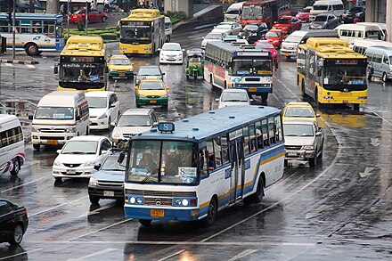 Many buses, minibuses and taxis share the streets with private vehicles at Victory Monument, a major public transport hub.