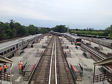 The station, as seen prior to its 2010s renovation. Belmont Park LIRR Station Overpass.JPG
