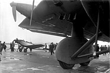 First prototype at Berlin Tempelhof Airport showing spatted tandem main wheels, the aileron section of the "double wing" and--most unusually--retractable oil and water radiators Bundesarchiv Bild 102-09776, Berlin-Tempelhof, Flugzeuge Junkers G 38 und A 50.jpg