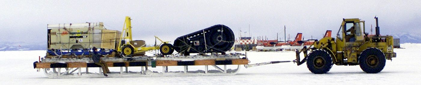 An enormous cargo sledge being maneuvered by a 10K-AT "All Terrain" forklift at McMurdo Station in Antarctica